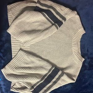 A grey knit crop top sweater with stripes
